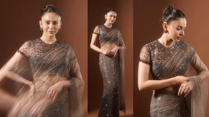 As excitement builds for Rakul Preet Singh’s upcoming film De De Pyaar De 2, set to release on November 14, 2025, the actor is making waves with her promotional appearances. During her recent visit to the sets of Bigg Boss 19, she turned heads in a dazzling brown saree that perfectly blended classic charm with modern sophistication. https://www.instagram.com/p/DQ1MZlXCl2X Rakul chose a mocha brown-black sequin saree designed by Tarun Tahiliani, showcasing how minimalism can still be captivating. The saree, richly covered in sequins, carried a luxurious sheen that needed no elaborate accessories. The blouse and pallu featured delicate droplet details, adding a subtle playfulness to the ensemble. The sheer blouse, embellished with scattered sequins, enhanced the elegance of the drape while highlighting Rakul’s graceful silhouette. On social media, she shared glimpses of her look and expressed heartfelt excitement for the journey ahead, hinting at new beginnings and stories yet to unfold. https://www.instagram.com/p/DQ1MZlXCl2X To maintain balance, Rakul kept her accessories simple, opting for studded rings and earrings. Her hair was styled in a sleek updo that added to the refined, contemporary aesthetic. For makeup, she embraced a soft and luminous look with gentle highlights, a touch of blush, and nude pink lips. By skipping bold eyeliner and heavy lashes, she proved that understated beauty can make a lasting impression. Rakul’s appearance was more than just a fashion statement — it was a lesson in effortless glamour. Her look perfectly captured the spirit of modern festive style, offering the ideal inspiration for anyone seeking elegance with a touch of sparkle this wedding season.
