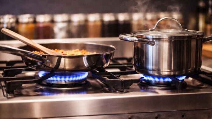 Indian kitchen gas stove with pressure cooker and covered vessels to reduce LPG consumption Indian kitchen gas stove with pressure cooker and covered vessels to reduce LPG consumption